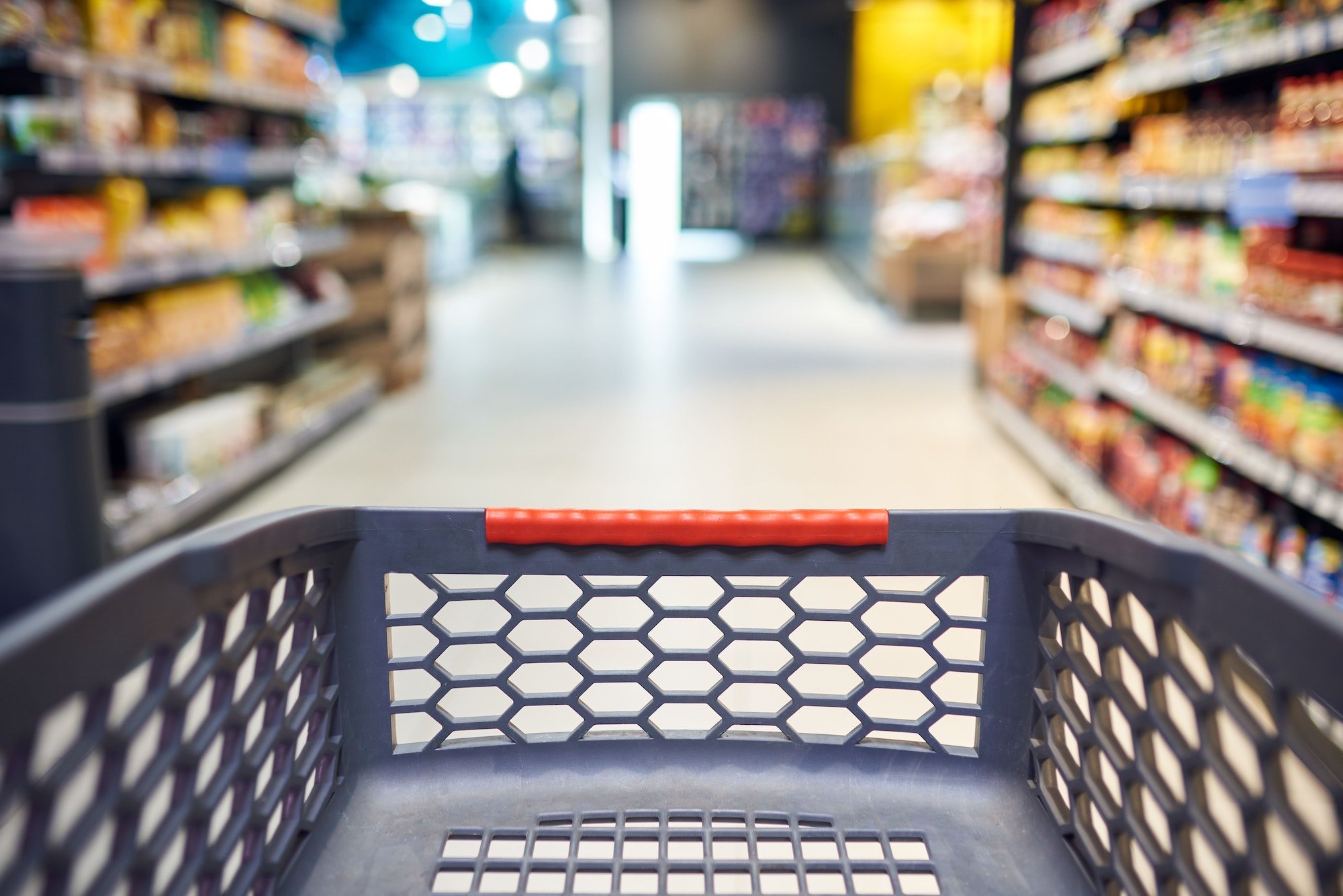 Abstract blurred photo of empty trolley in supermarket